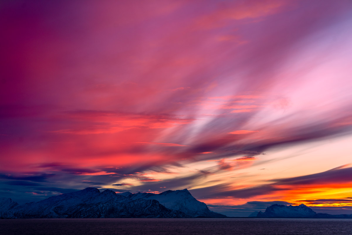 When the sea meets snow covered mountains and the warm glow of sunset (c) Rune Nilsen