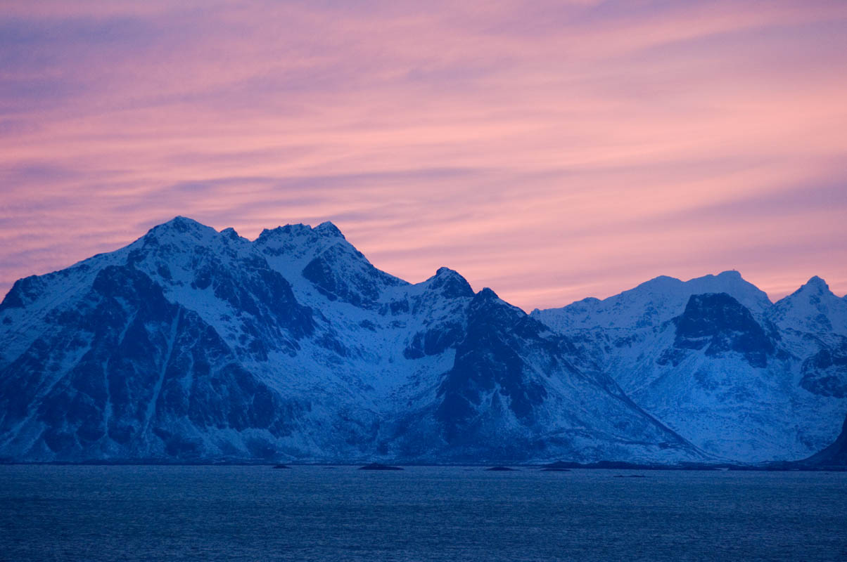 Snow plastered mountains backdropped by soft sunset (C) Terje Rakke Nordic Life
