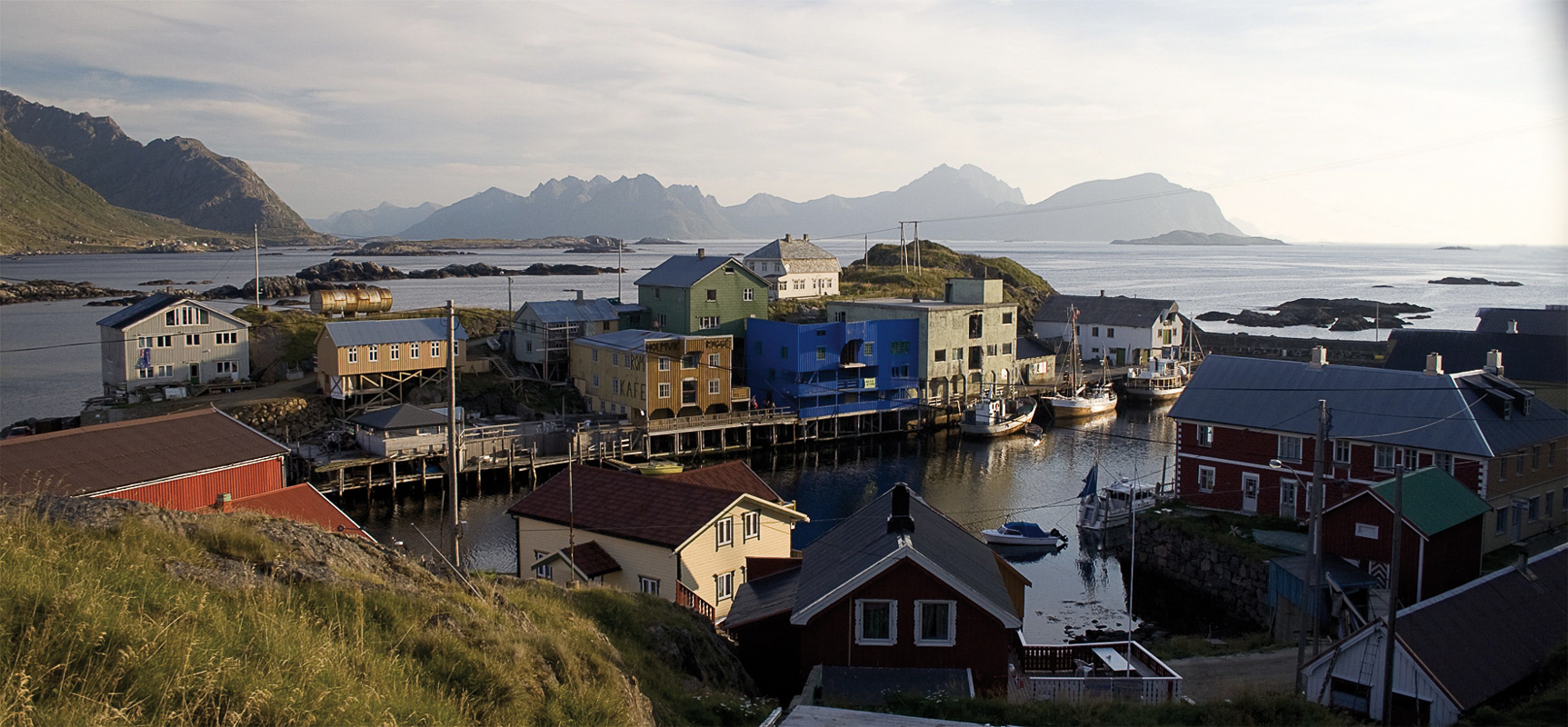 The Port of Nyksund, viewed from a little hillside protecting against the Atlantic. The breakwater is to the right, and the entrance to the port is from the left © Visit Vesterålen