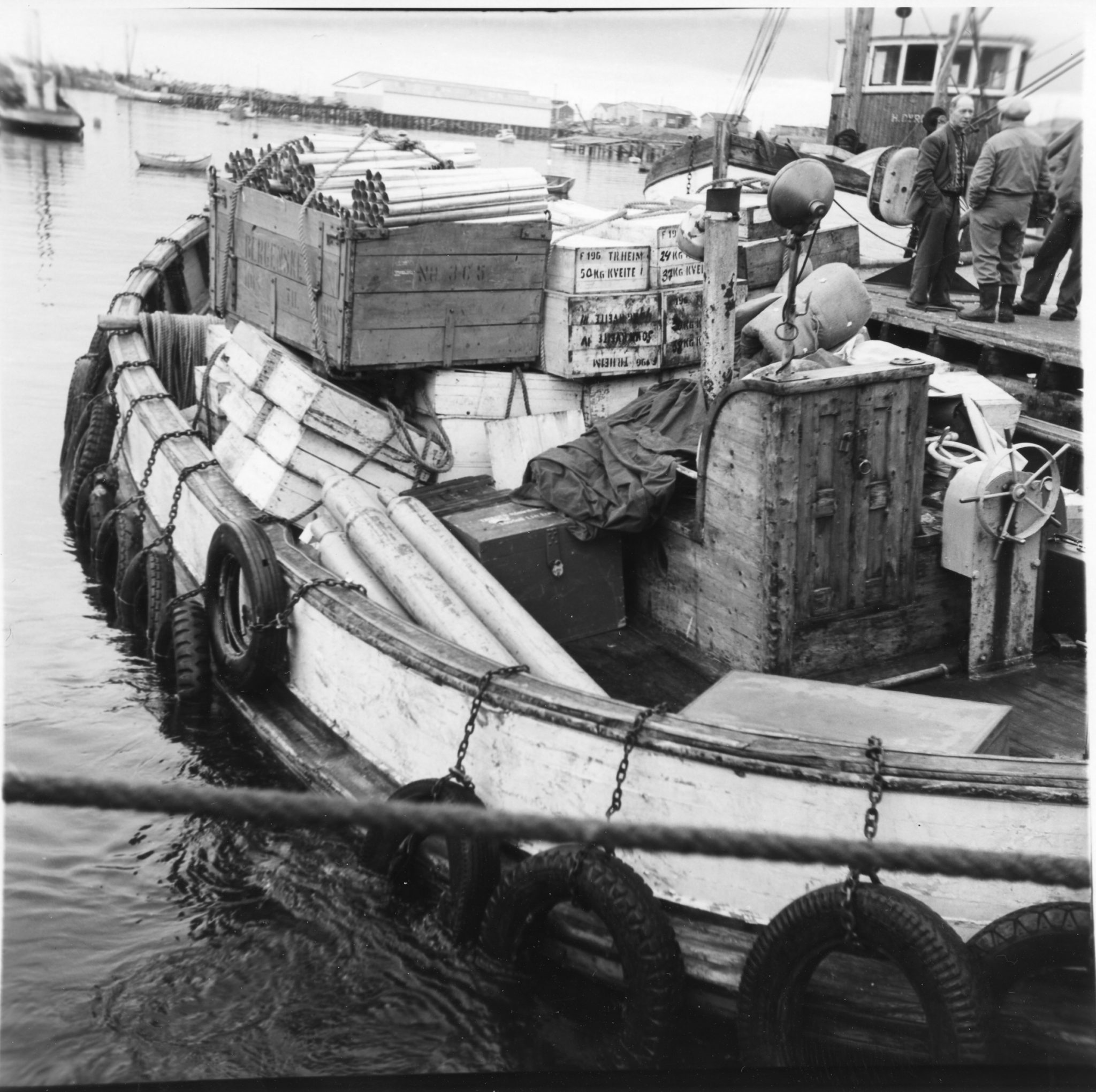 The transport boat, pramma, is fully loaded with goods. There was no road to Berlevåg, so the hurtigruten and the pramma were the only way to get goods to and from Berlevåg © Havnemuseet i Berlevåg