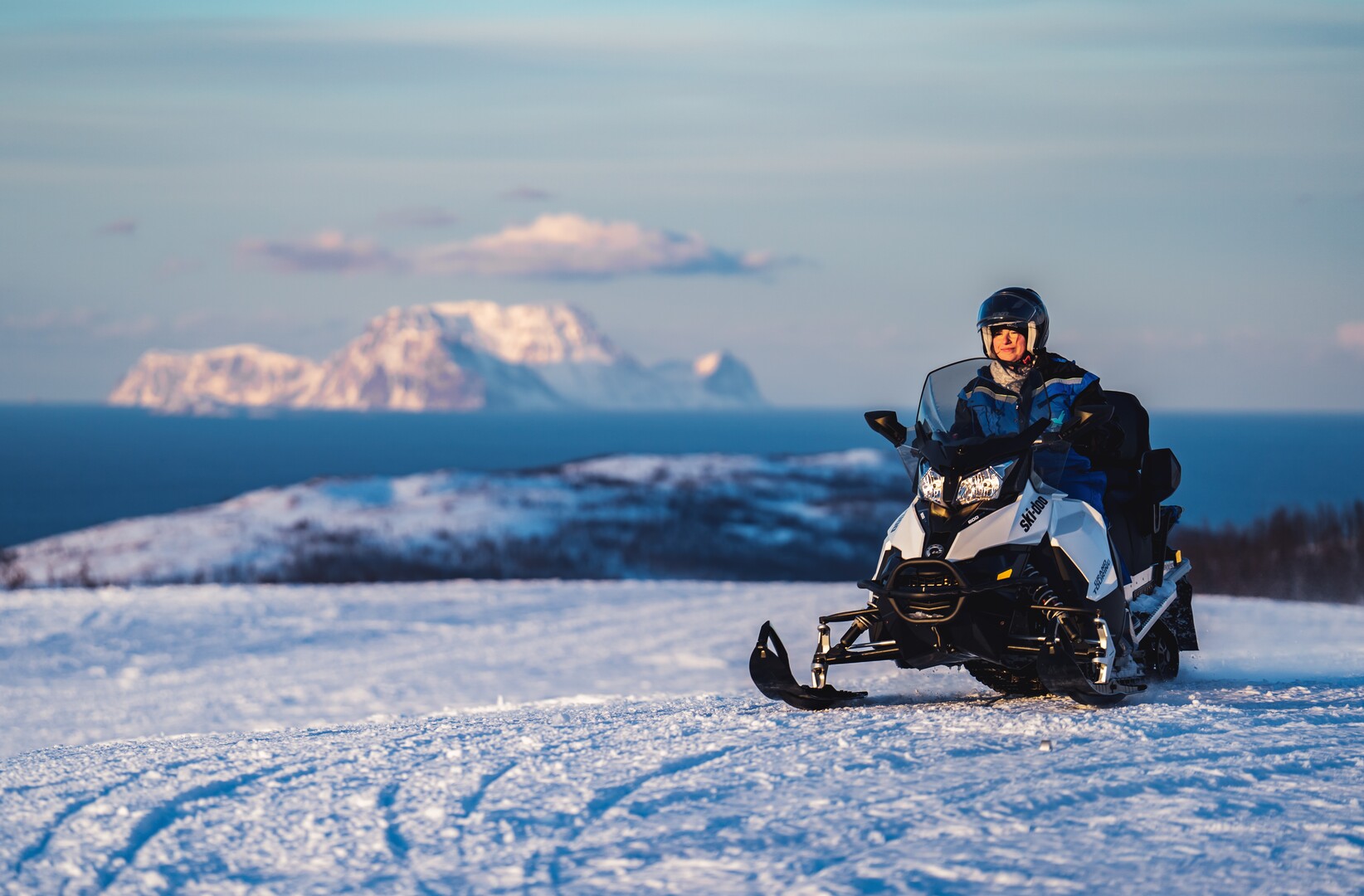 From outer Lyngenfjord with the island of Nord-Fugløy in the far back. And a snowmobile © Petr Pavlíček / Visit Lyngenfjord