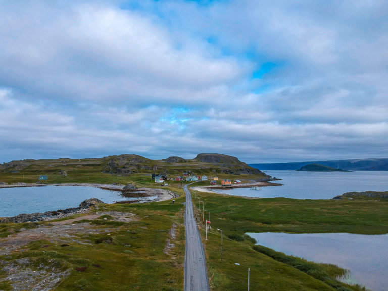 Heading towards Veidnes. The peninsula behind the houses has a WWII fort, a architecturally designed bird shed and white tailed eagles © Katelin Pell
