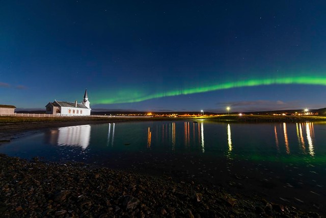 Church of Nesseby and a green Northern Lights ribbon over the village in the back © Bjarne Riesto, riesto.no / Statens vegvesen
