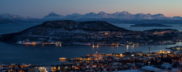 Blue midwinter light in Harstad: In front the city centre, in the far back the peaks of Rolla island © Øivind Arvola / Harstad kommune
