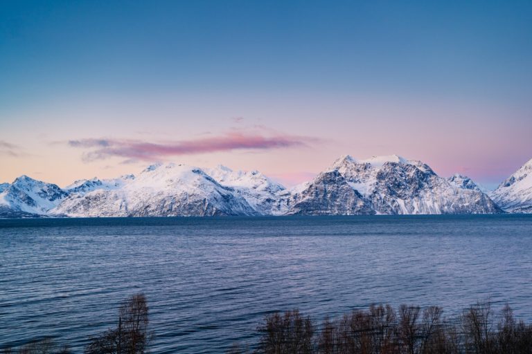 Mighty peaks under the pink and blue of the polar night dawn © Petr Pavlíček / Visit Lyngenfjord