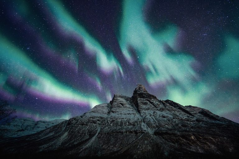 Powerful Northern Lights eruption over Mount Otertinden in Storfjord, the innermost of the Lyngen Fjord © Petr Pavlíček / Visit Lyngenfjord