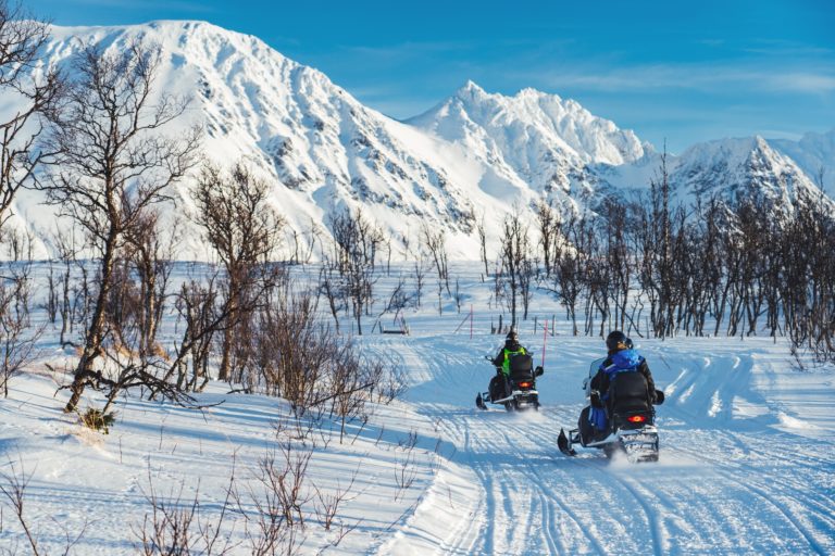 On snowmobiles at the Northern end of the Lyngen Alps peninsula © Petr Pavlíček / Visit Lyngenfjord