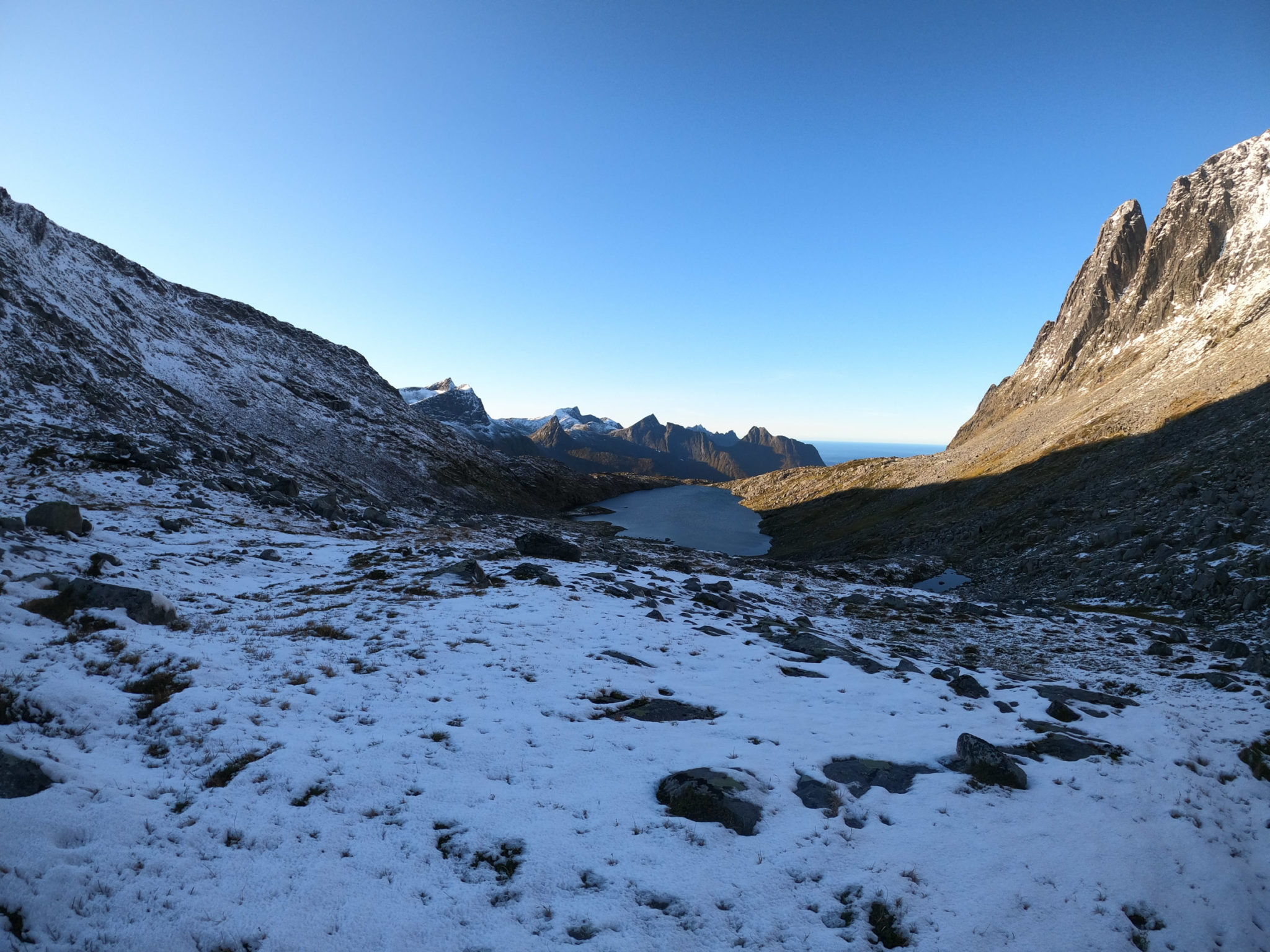Snow in the autumn mountains of Senja, with the Atlantic way out there © Kristin Harila