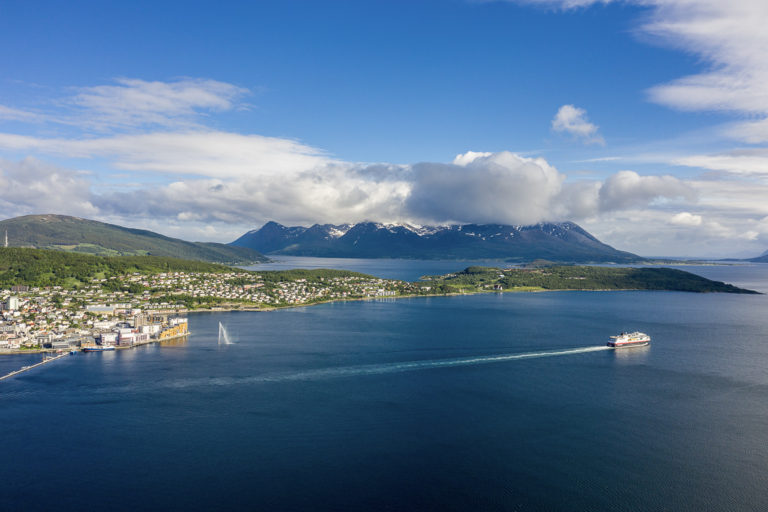 The north bound Hurtigruten sailing out, with the Trondenes peninsula in the background, and the steep mountains of Grytøya in the far back © Dag Roland