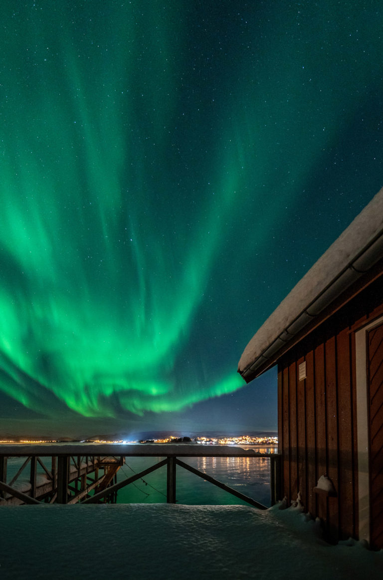 Faraway lights at Gibostad, and the Northern Lights dancing over Senja. Viewed from Lenvik museum © Dag Arild Larsen/Midt-Troms Museum