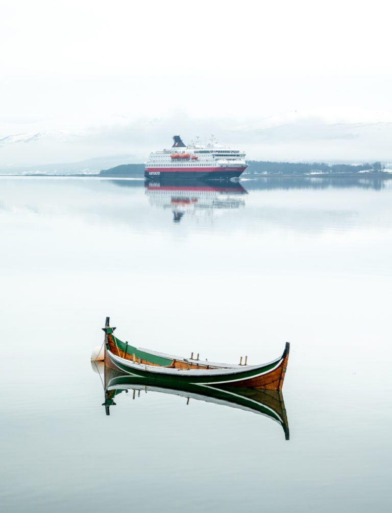 The small, local boat bindalsfæring and the big Hurtigruten ship on a calm, foggy day © Dag Arild Larsen/Midt-Troms Museum