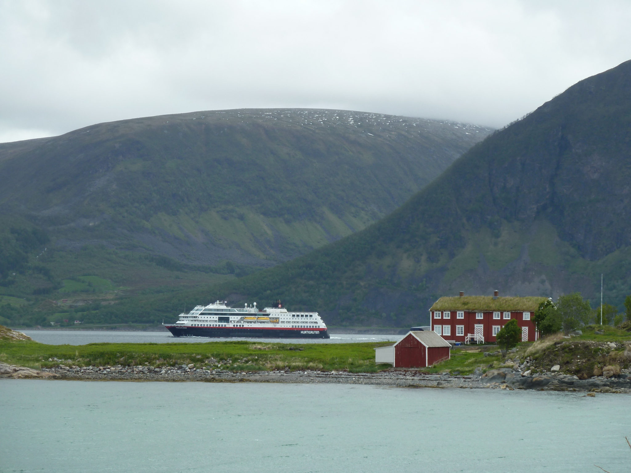 The old house at Elgsnes, the Raten promontory, the waterway of Toppsundet and the distant mountains on Grytøya Island - When all communications went by sea, Elgsnes enjoyed a central location © Dag-Magnus Andreassen / Troms Fylkeskommune