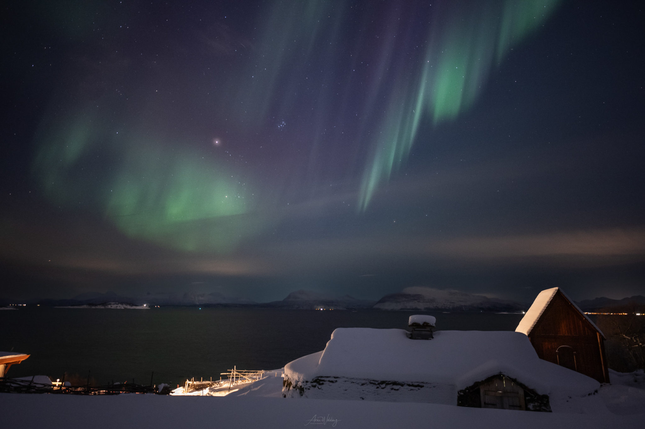 A mediaeval longhouse and a stave church under the Northern Lights at Trondenes near Harstad © Arne Widding