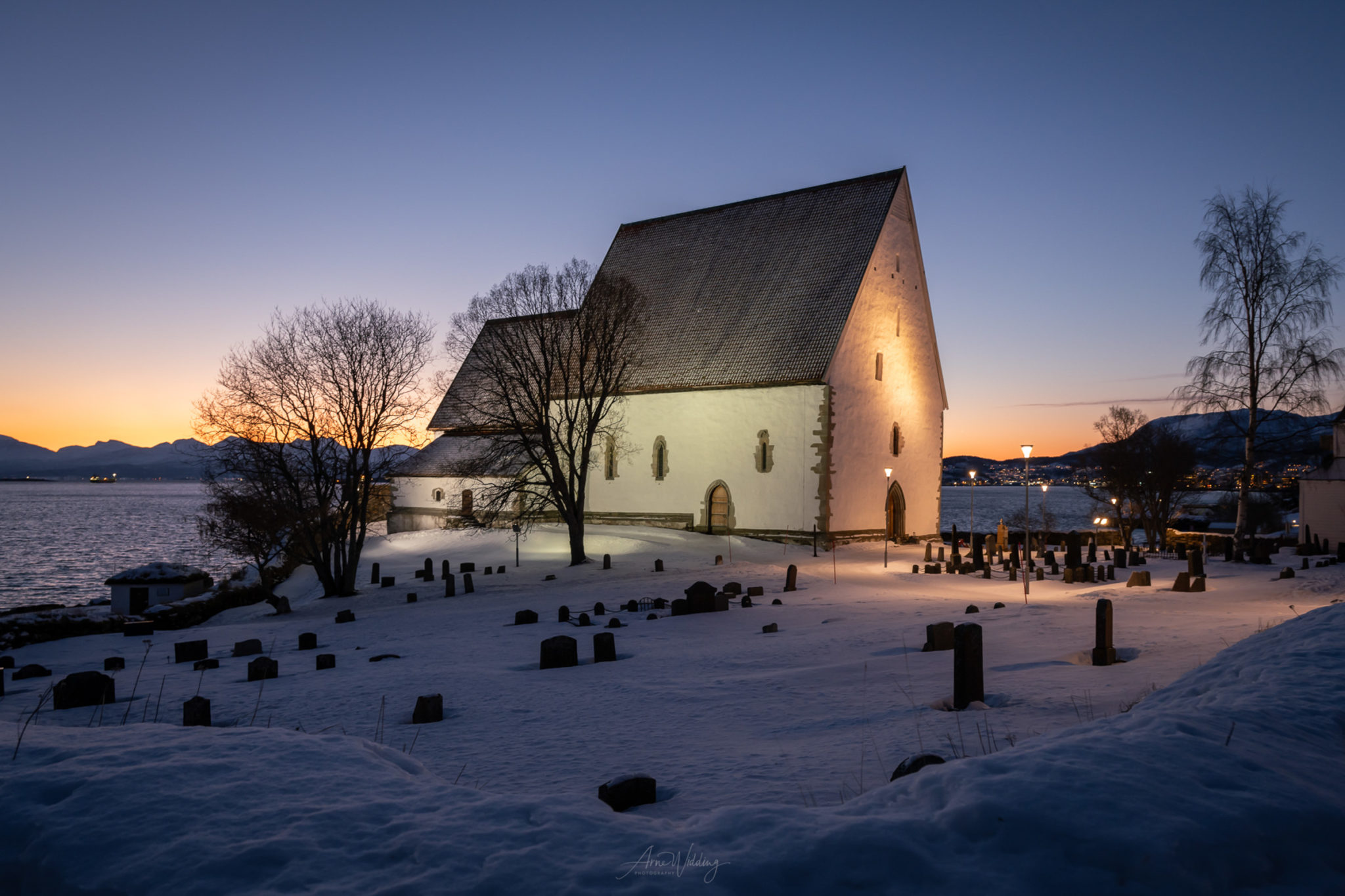 Church of Trondenes in winter dusk © Arne Widding