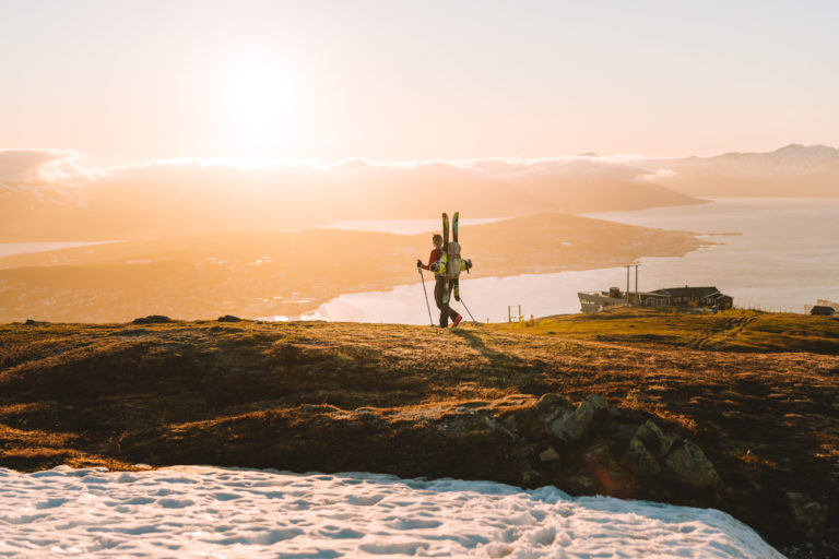 Skiing season stretches well into June on Fløya in Tromsø, offering the chance to ski under the midnight sun. But be prepared to carry your skis. © Vegard Stien / Raw Studios