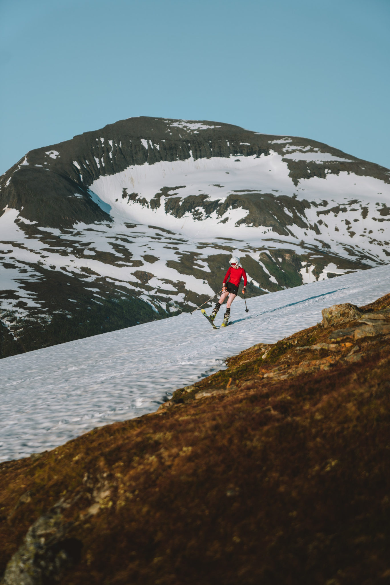 Shorts-clad skiing joy at midnight in June on Fløya, Tromsø © Vegard Stien / Raw Studios
